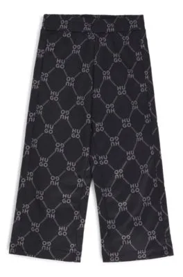 Kids' loose-fit tracksuit bottoms with stacked-logo print