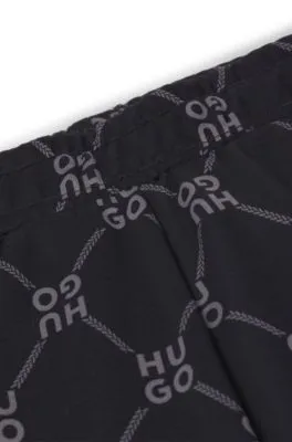 Kids' loose-fit tracksuit bottoms with stacked-logo print