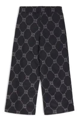 Kids' loose-fit tracksuit bottoms with stacked-logo print