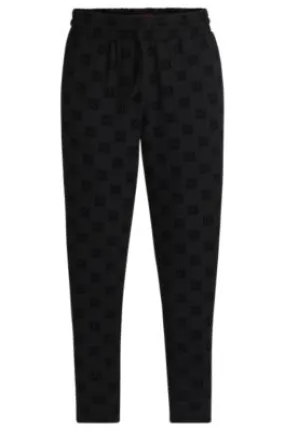 Straight-leg tracksuit bottoms with flock-print stacked logos